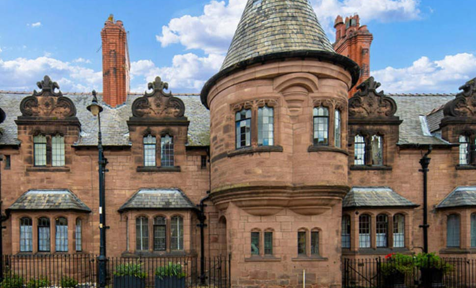 A sandstone building with turrets