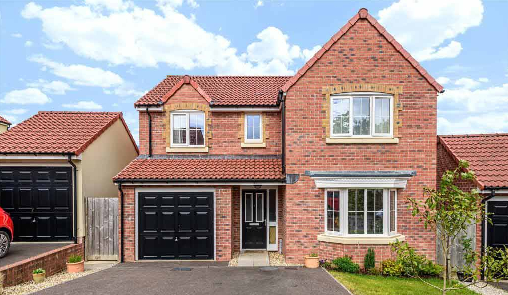 A detached house with a garage and driveway