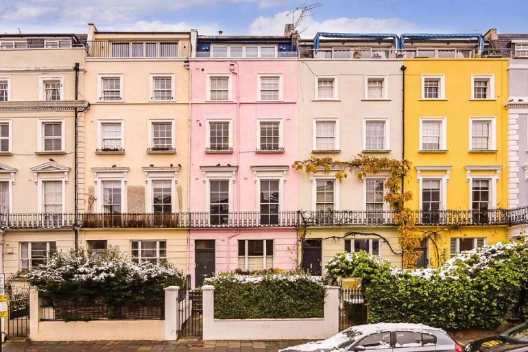 A row of colourful townhouses in west London