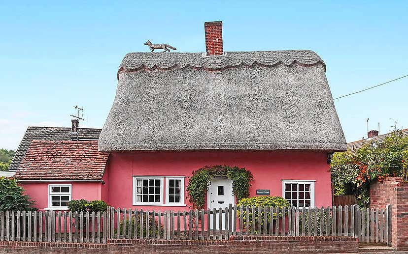 A pink thatched cottage