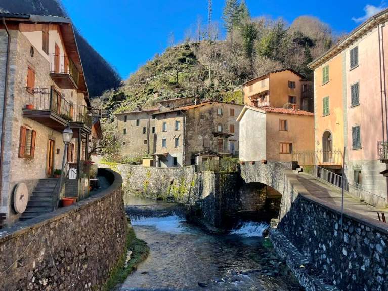 A river and buildings in a Tuscan village