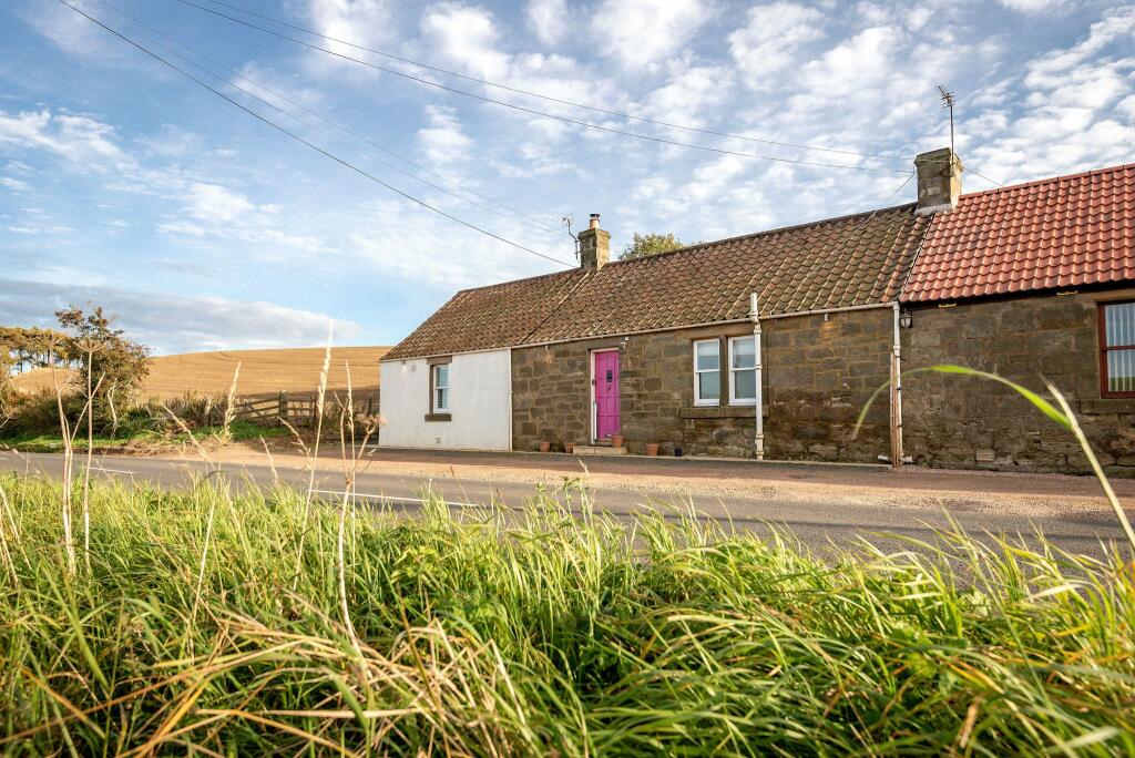 Single storey cottage, blue sky, grass