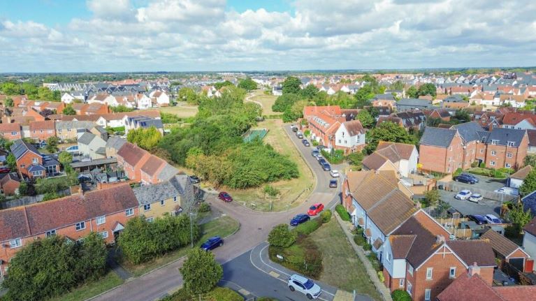 An aerial view of houses, a road