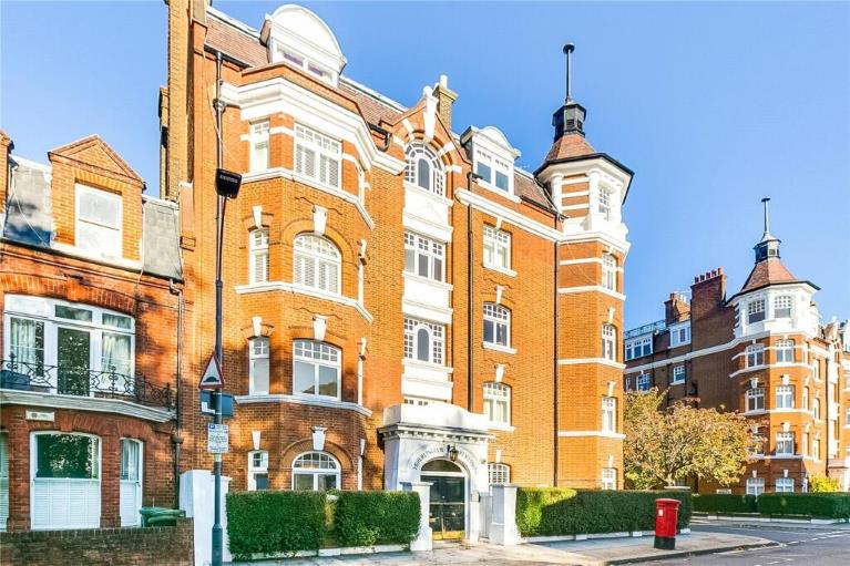 A red brick building with ornate detail, blue sky