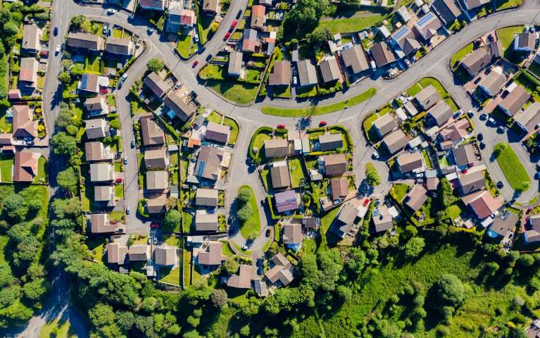 An aerial view of houses, trees