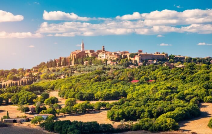 A medieval town in rural Italy surrounded by lush green trees