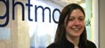 Girl smiling infront of Rightmove sign